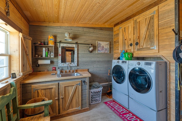 10 Berkshire Rd, Estancia, NM 87016 - washroom with washing machine and dryer, wood walls, cabinet space, wooden ceiling, and light carpet