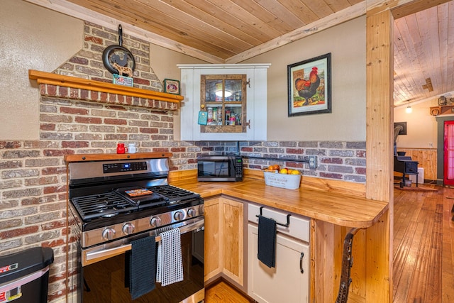 10 Berkshire Rd, Estancia, NM 87016 - kitchen featuring stainless steel range with gas stovetop, wood ceiling, wood counters, black microwave, and light wood-type flooring