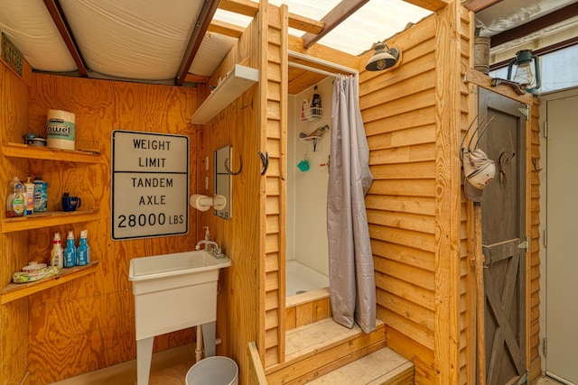 10 Berkshire Rd, Estancia, NM 87016 - full bath featuring a shower with shower curtain and wooden walls