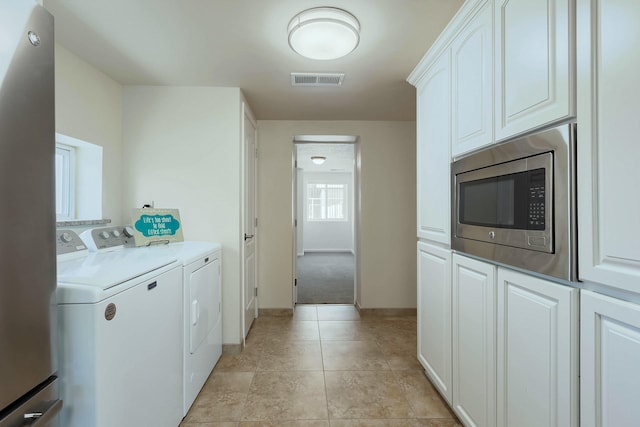 1201 Calle Placitas, Bernalillo, NM 87004 - washroom featuring separate washer and dryer, light tile patterned floors, and cabinet space
