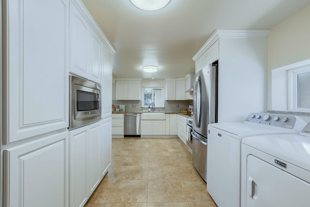 1201 Calle Placitas, Bernalillo, NM 87004 - kitchen with stainless steel appliances, washing machine and dryer, white cabinets, and light countertops