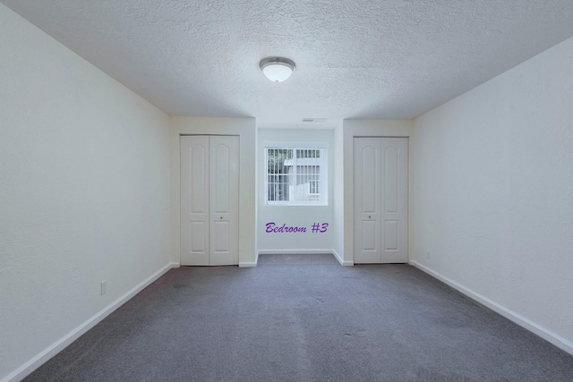 1201 Calle Placitas, Bernalillo, NM 87004 - unfurnished bedroom with two closets, carpet flooring, and a textured ceiling