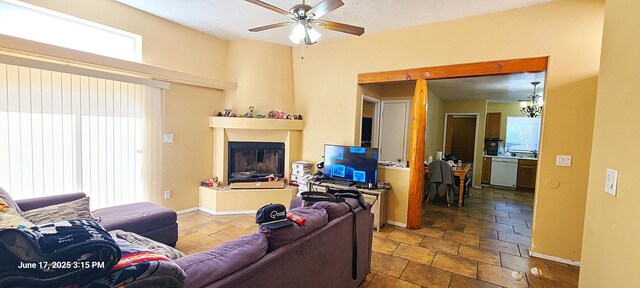 441 Colonial Ave SW, Los Lunas, NM 87031 - living room with ceiling fan, stone tile flooring, and a glass covered fireplace