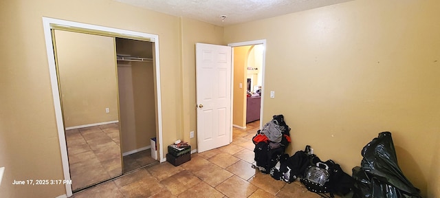 441 Colonial Ave SW, Los Lunas, NM 87031 - unfurnished bedroom with a textured ceiling and a closet