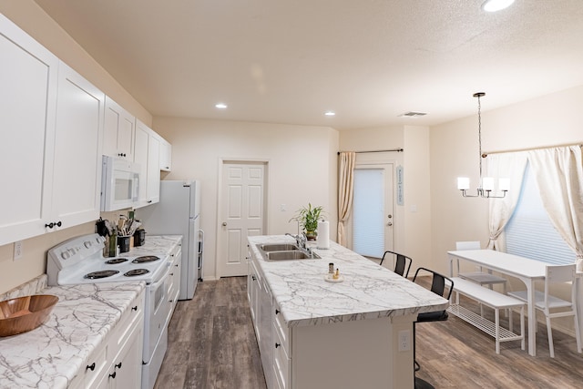 602 Camino Andres, Moriarty, NM 87035 - kitchen with white appliances, dark wood finished floors, a kitchen island with sink, white cabinetry, and recessed lighting