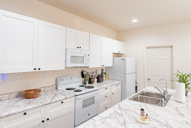 602 Camino Andres, Moriarty, NM 87035 - kitchen featuring white appliances, white cabinets, recessed lighting, and light stone counters