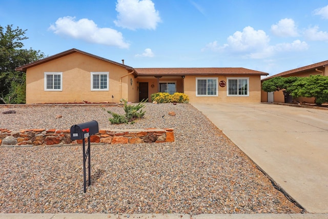 302 Damon St, Rio Communities, NM 87002 - single story home featuring stucco siding and driveway