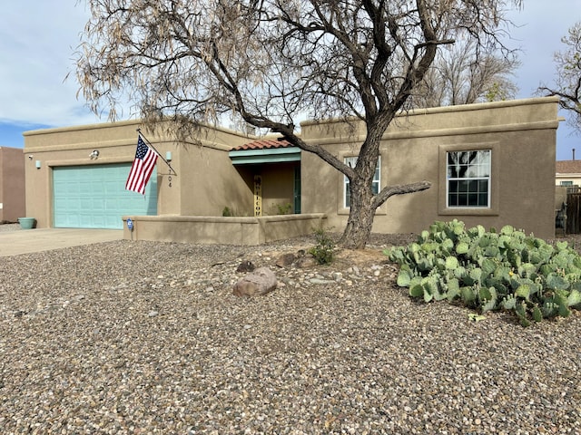 1704 Jack Nicklaus Dr, Rio Communities, NM 87002 - southwest-style home featuring stucco siding, concrete driveway, and an attached garage
