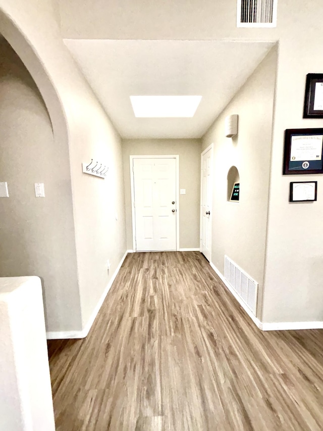1704 Jack Nicklaus Dr, Rio Communities, NM 87002 - entryway with wood finished floors, a skylight, baseboards, and arched walkways