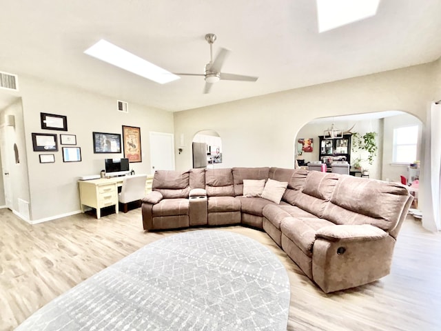 1704 Jack Nicklaus Dr, Rio Communities, NM 87002 - living area with arched walkways, light wood-style flooring, and ceiling fan