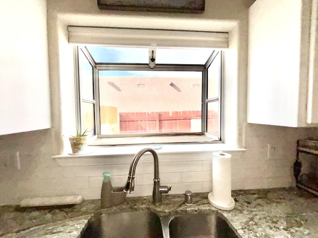 1704 Jack Nicklaus Dr, Rio Communities, NM 87002 - kitchen view of tasteful backsplash, a sink, and white cabinets