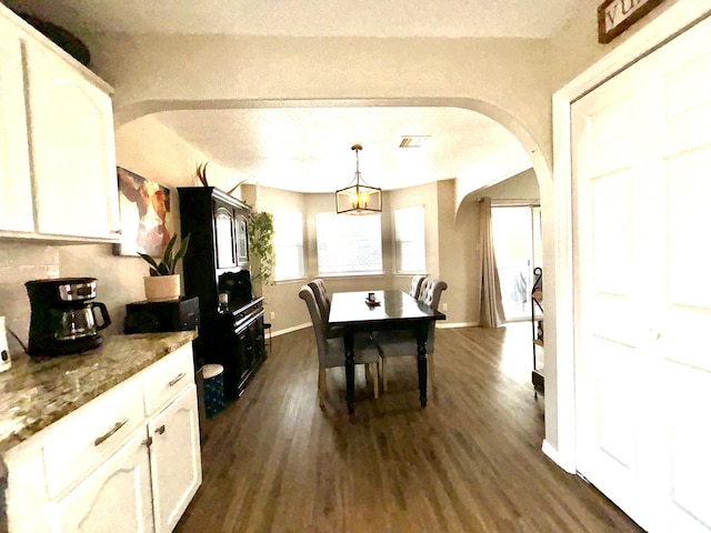 1704 Jack Nicklaus Dr, Rio Communities, NM 87002 - dining area with arched walkways and dark wood-type flooring