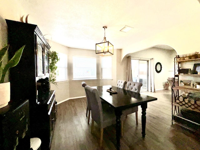 1704 Jack Nicklaus Dr, Rio Communities, NM 87002 - dining area featuring arched walkways, plenty of natural light, and dark wood-style flooring