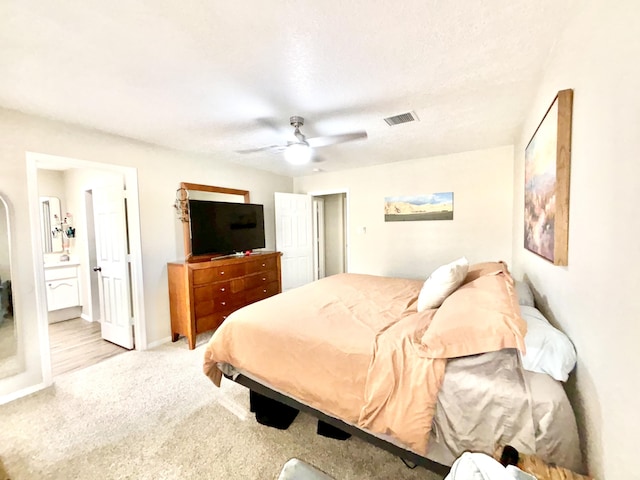 1704 Jack Nicklaus Dr, Rio Communities, NM 87002 - carpeted bedroom featuring a ceiling fan and ensuite bath