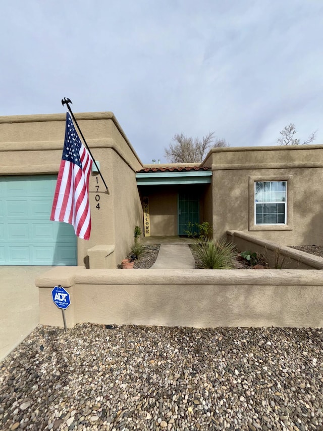 1704 Jack Nicklaus Dr, Rio Communities, NM 87002 - view of front of property featuring stucco siding and a garage