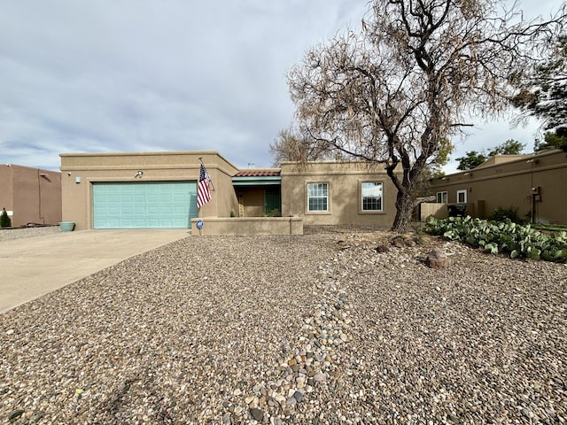 1704 Jack Nicklaus Dr, Rio Communities, NM 87002 - view of front of house with concrete driveway, stucco siding, and an attached garage