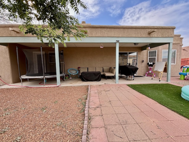 1704 Jack Nicklaus Dr, Rio Communities, NM 87002 - back of property featuring stucco siding, a patio area, and an outdoor hangout area