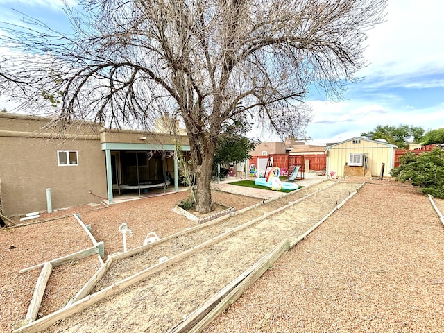 1704 Jack Nicklaus Dr, Rio Communities, NM 87002 - view of yard featuring a playground and an outbuilding
