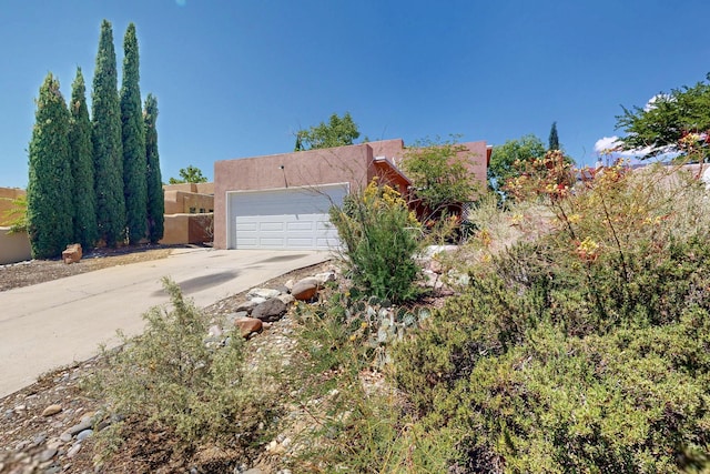 7939 Independence Dr NW, Albuquerque, NM 87120 - view of front facade with stucco siding, concrete driveway, and a garage