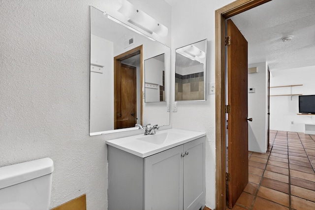 7939 Independence Dr NW, Albuquerque, NM 87120 - half bathroom with a textured wall, vanity, and tile patterned flooring