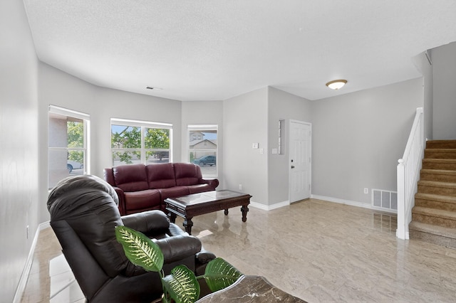 1468 Montiano Loop SE, Rio Rancho, NM 87124 - living area featuring stairs, a textured ceiling, and light marble finish floors