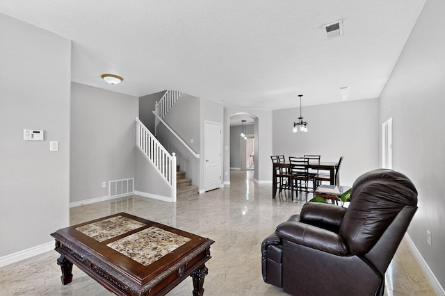 1468 Montiano Loop SE, Rio Rancho, NM 87124 - living room featuring arched walkways, stairs, and light marble finish flooring