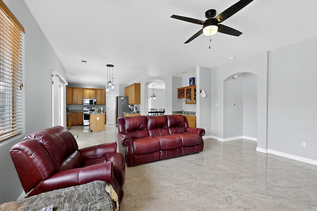 1468 Montiano Loop SE, Rio Rancho, NM 87124 - living area featuring arched walkways, a ceiling fan, and light marble finish floors