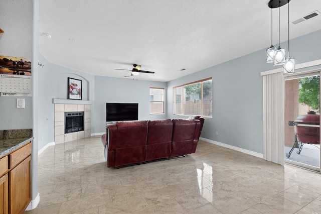 1468 Montiano Loop SE, Rio Rancho, NM 87124 - living room featuring light marble finish flooring, ceiling fan, and a tile fireplace