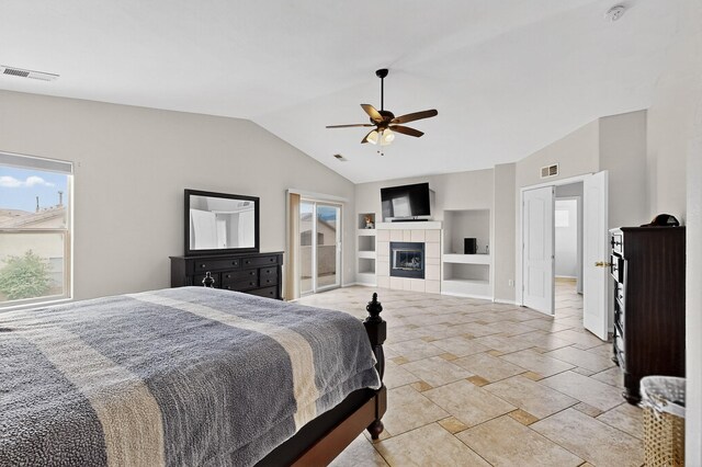 1468 Montiano Loop SE, Rio Rancho, NM 87124 - bedroom featuring multiple windows, lofted ceiling, a tile fireplace, and ceiling fan