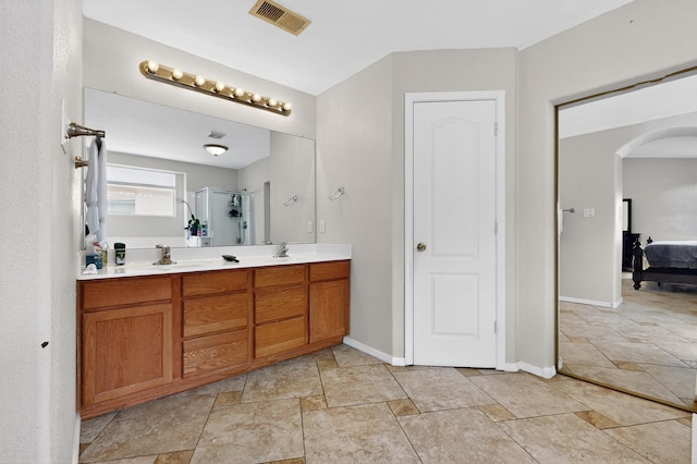 1468 Montiano Loop SE, Rio Rancho, NM 87124 - full bath featuring double vanity, stone tile flooring, a shower with shower door, and ensuite bath
