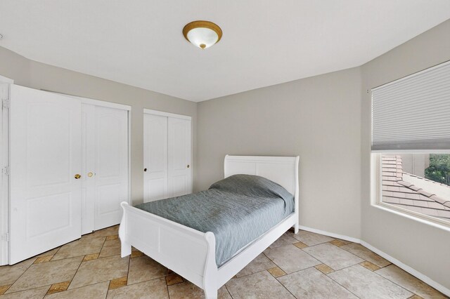 1468 Montiano Loop SE, Rio Rancho, NM 87124 - bedroom with multiple closets and light stone finish flooring