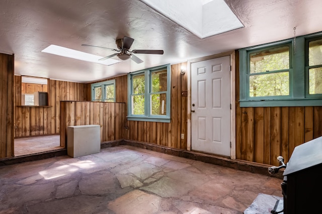 88 Tejano Canyon Rd, Sandia Park, NM 87047 - foyer entrance featuring stone finish flooring, wood walls, and a ceiling fan