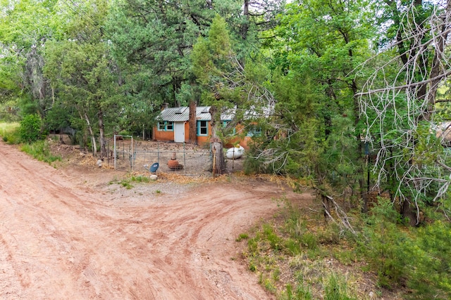 88 Tejano Canyon Rd, Sandia Park, NM 87047 - view of front facade with an outdoor structure and a view of trees