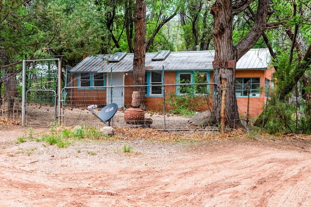 88 Tejano Canyon Rd, Sandia Park, NM 87047 - single story home with a gate and a metal roof