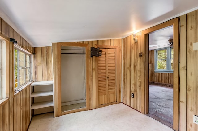 88 Tejano Canyon Rd, Sandia Park, NM 87047 - unfurnished bedroom with wood walls and tile patterned floors