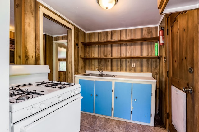 88 Tejano Canyon Rd, Sandia Park, NM 87047 - kitchen featuring open shelves, white range with gas cooktop, blue cabinets, wooden walls, and light countertops