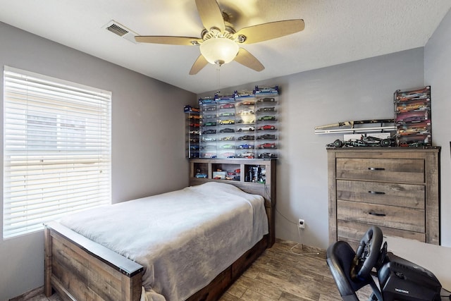 2704 Ghost Ranch St SW, Albuquerque, NM 87121 - bedroom featuring wood finished floors and a ceiling fan