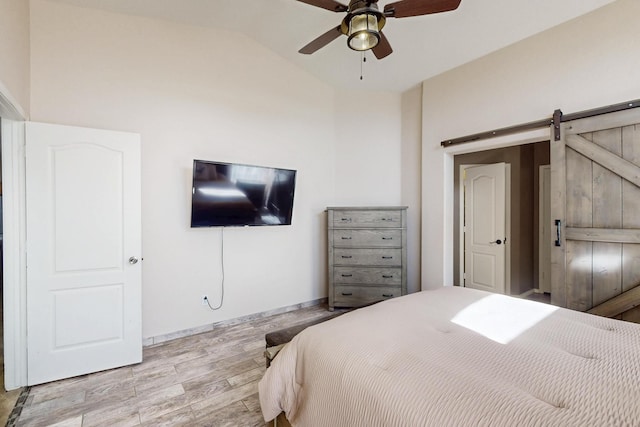 2704 Ghost Ranch St SW, Albuquerque, NM 87121 - bedroom with lofted ceiling, wood finished floors, a barn door, and ceiling fan