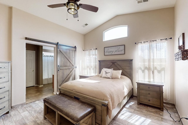2704 Ghost Ranch St SW, Albuquerque, NM 87121 - bedroom featuring a barn door, light wood-style flooring, ceiling fan, and high vaulted ceiling