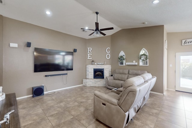 2704 Ghost Ranch St SW, Albuquerque, NM 87121 - living area featuring vaulted ceiling, a ceiling fan, light tile patterned floors, a stone fireplace, and recessed lighting