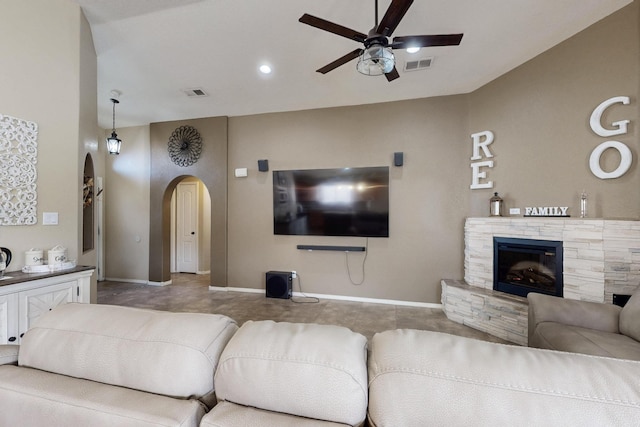 2704 Ghost Ranch St SW, Albuquerque, NM 87121 - living area with arched walkways, a ceiling fan, and a stone fireplace