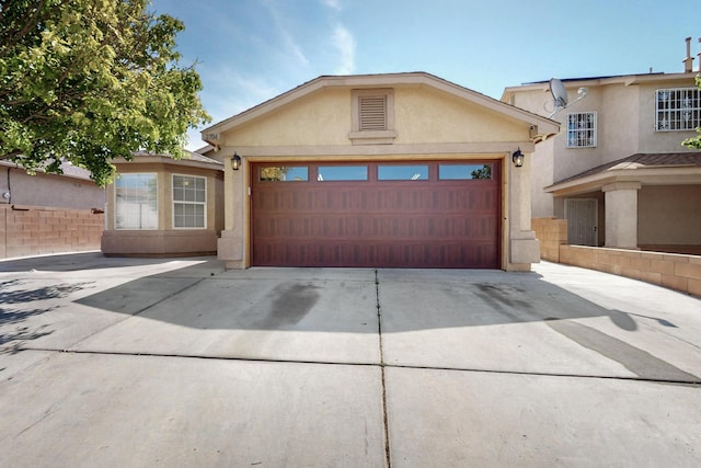 2704 Ghost Ranch St SW, Albuquerque, NM 87121 - view of front of house with stucco siding, concrete driveway, and an attached garage