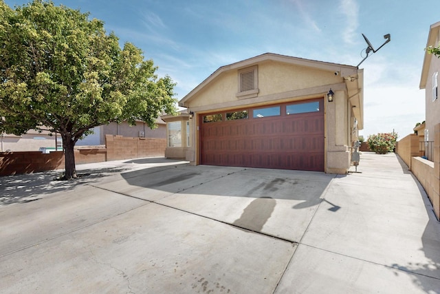 2704 Ghost Ranch St SW, Albuquerque, NM 87121 - view of front of house featuring stucco siding, a garage, and concrete driveway