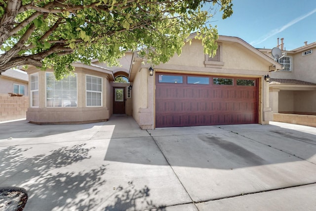 2704 Ghost Ranch St SW, Albuquerque, NM 87121 - view of front of house with stucco siding, concrete driveway, and an attached garage