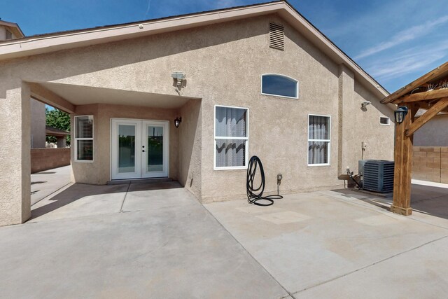 2704 Ghost Ranch St SW, Albuquerque, NM 87121 - back of house with french doors, stucco siding, and a patio area