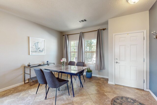 613 Loma Linda Loop NE, Rio Rancho, NM 87124 - dining room featuring a textured ceiling and baseboards