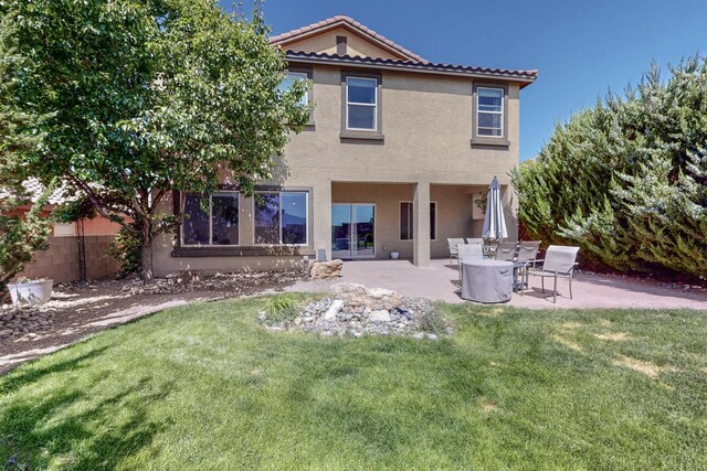 613 Loma Linda Loop NE, Rio Rancho, NM 87124 - rear view of house featuring stucco siding, a tiled roof, and a patio