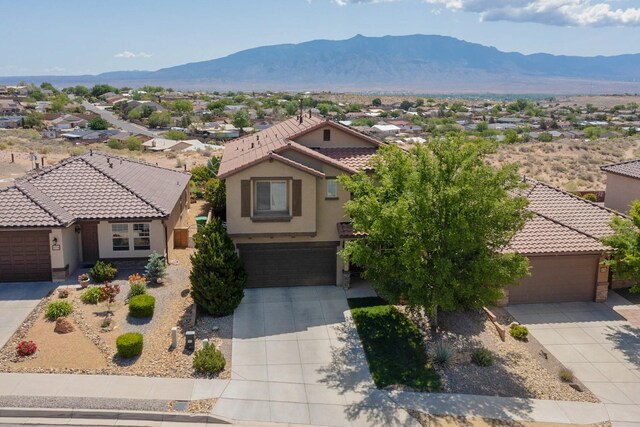 613 Loma Linda Loop NE, Rio Rancho, NM 87124 - view of front facade featuring concrete driveway, a mountain view, stucco siding, and a residential view