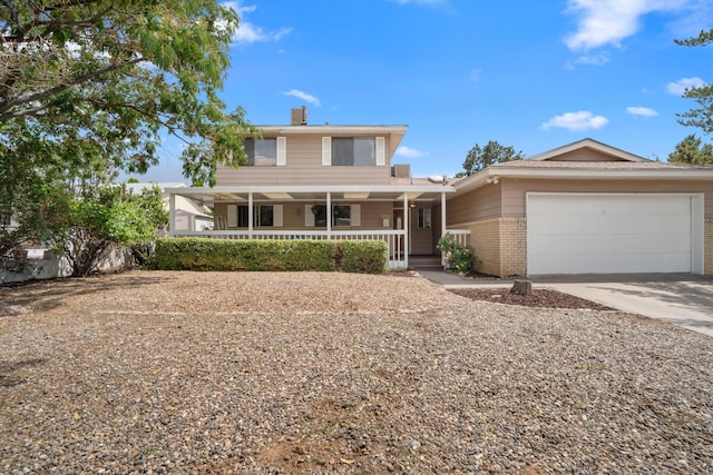 9200 Lagrima De Oro Rd NE, Albuquerque, NM 87111 - farmhouse-style home with covered porch, an attached garage, driveway, and brick siding