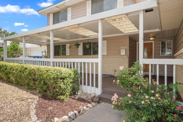9200 Lagrima De Oro Rd NE, Albuquerque, NM 87111 - view of exterior entry with covered porch and brick siding
